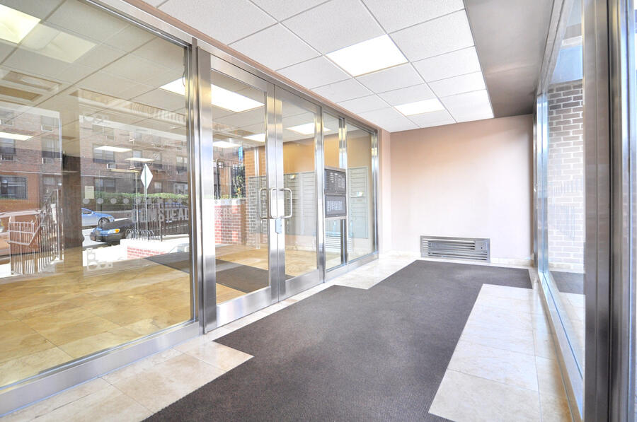 Lobby entry vestibule with glass doors at The Olmstead